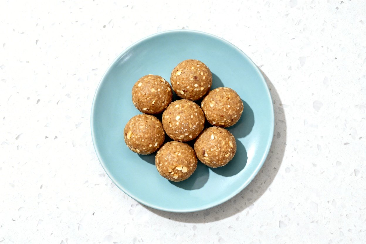 top-down food photo of the finished no-bake keto protein balls: a single serving of 8 round, bite-si