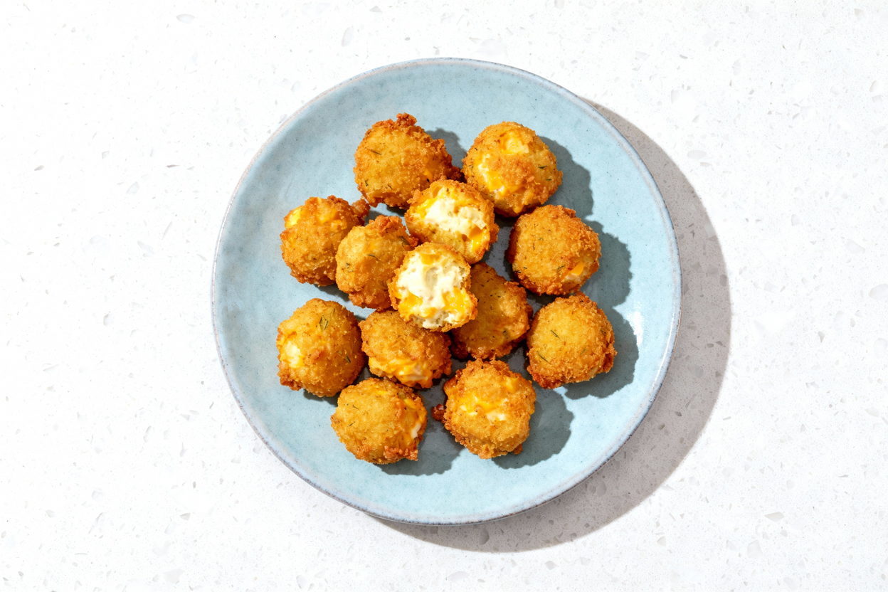 t blue ceramic plate centered on a white stone countertop, holding a single serving of fried dill pi