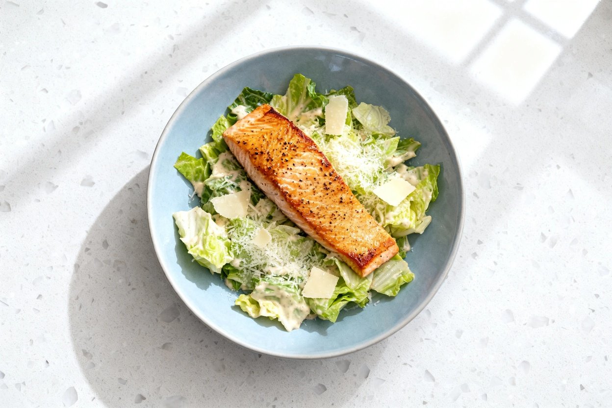 top-down food photograph of a keto Low Carb Salmon Caesar Salad: a single serving centered on an ide