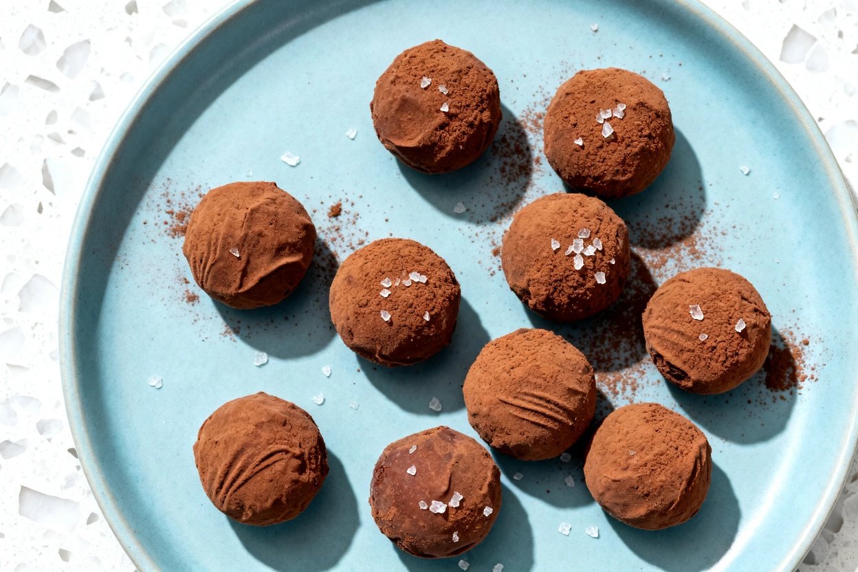 top-down food photo of keto nut butter fat bombs: 8–10 small, truffle-like balls (about 1 inch each
