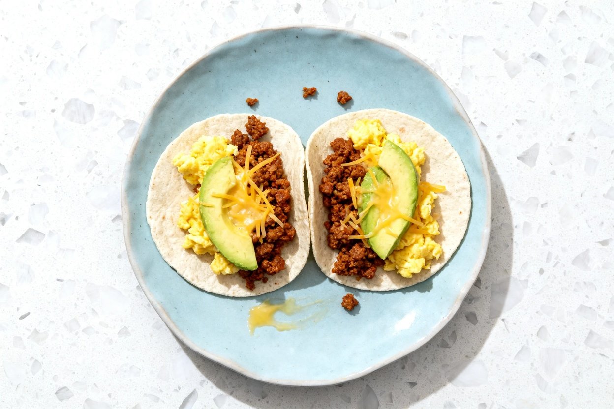top-down food photo of keto chorizo breakfast tacos: two small tacos made with coconut flour tortill