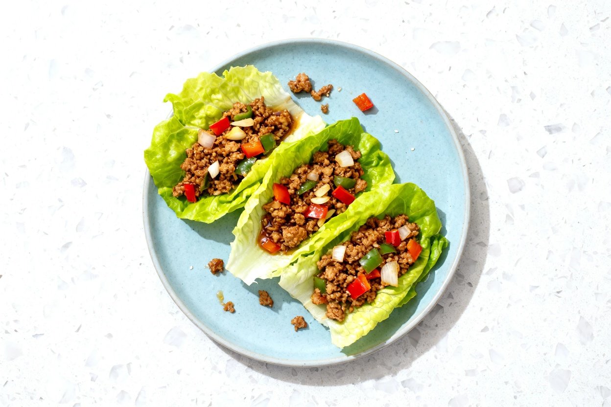 top-down food photo of keto turkey lettuce wraps: a single serving arranged as 3–4 crisp romaine (o